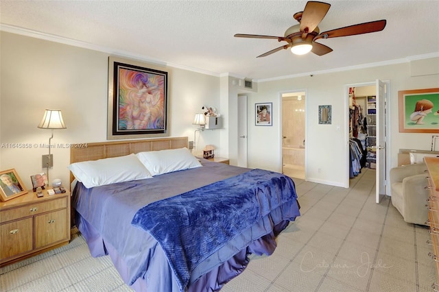 bedroom featuring ensuite bath, a closet, a spacious closet, ceiling fan, and ornamental molding