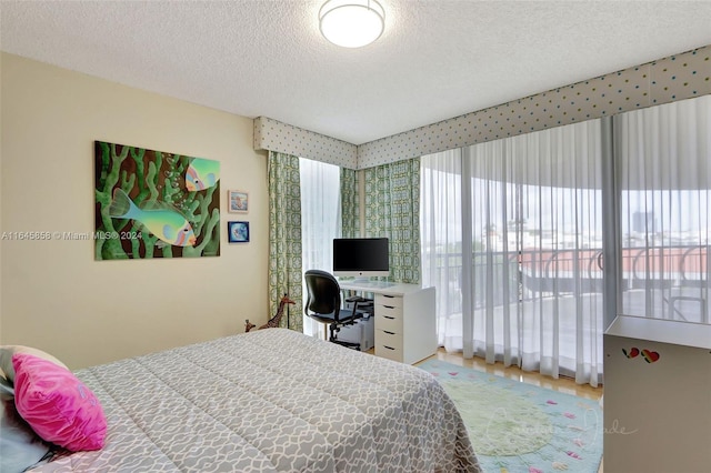 bedroom featuring a textured ceiling and light hardwood / wood-style floors