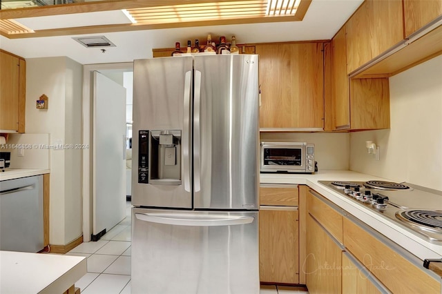 kitchen featuring appliances with stainless steel finishes and light tile patterned floors