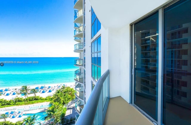 balcony with a beach view and a water view