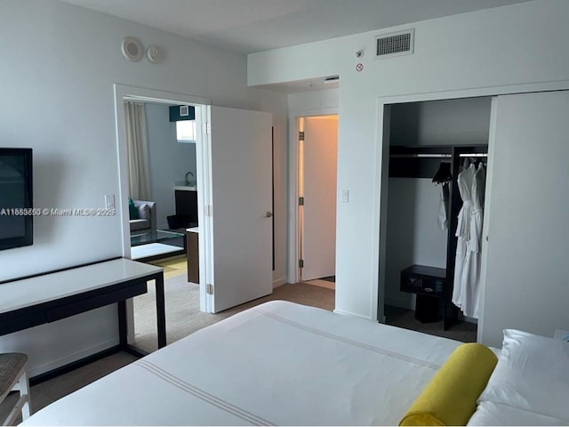 carpeted bedroom featuring a closet