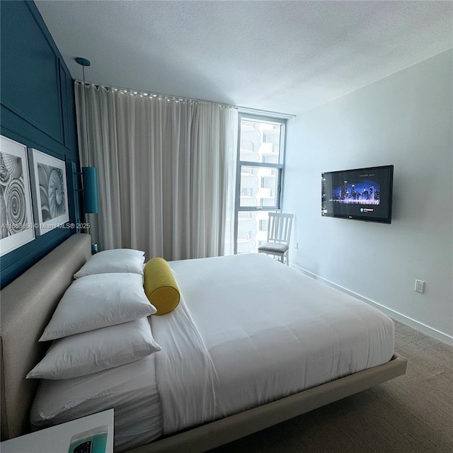 carpeted bedroom featuring a textured ceiling