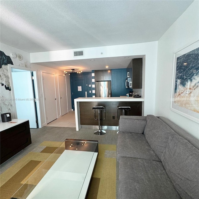 carpeted living room with a textured ceiling