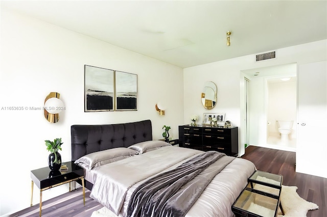 bedroom with dark hardwood / wood-style floors and ensuite bathroom