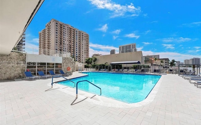 view of swimming pool featuring a patio