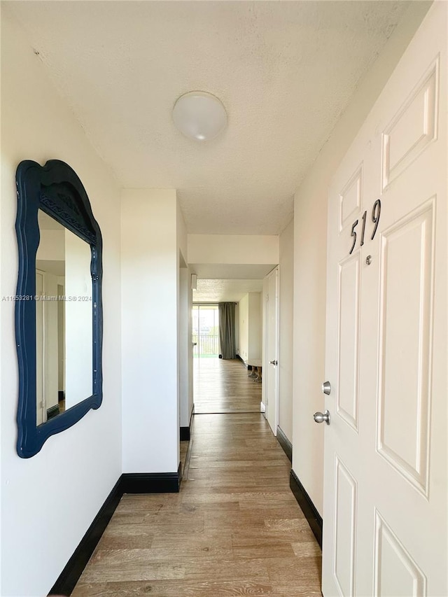 hallway with light hardwood / wood-style flooring