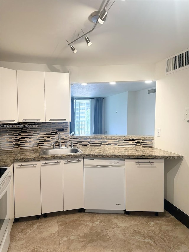 kitchen featuring white cabinetry, stone countertops, white appliances, and sink