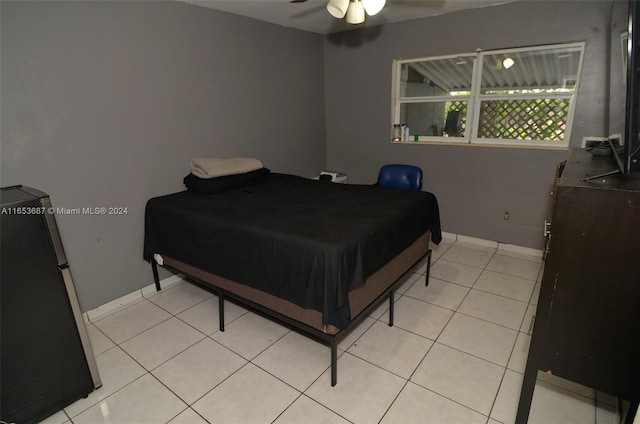 bedroom with ceiling fan, refrigerator, and light tile patterned floors