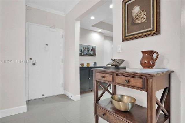 foyer entrance featuring ornamental molding and light tile patterned flooring