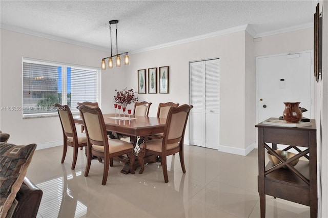 tiled dining room with crown molding and a textured ceiling