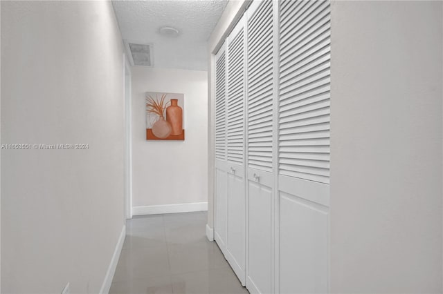 hallway featuring a textured ceiling