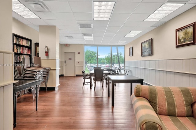 dining space featuring dark wood-type flooring and a paneled ceiling