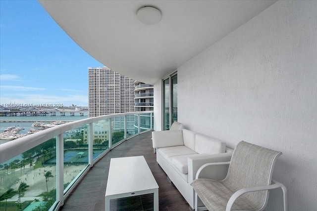 balcony featuring a water view and an outdoor hangout area