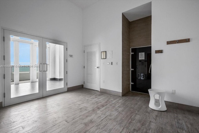 interior space with hardwood / wood-style floors and a high ceiling