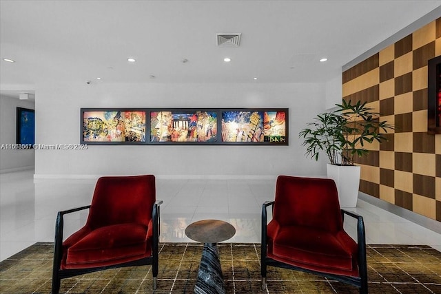 living area featuring dark tile patterned flooring