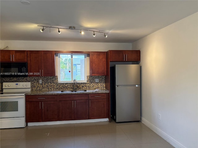 kitchen with sink, backsplash, light tile patterned floors, electric stove, and stainless steel refrigerator