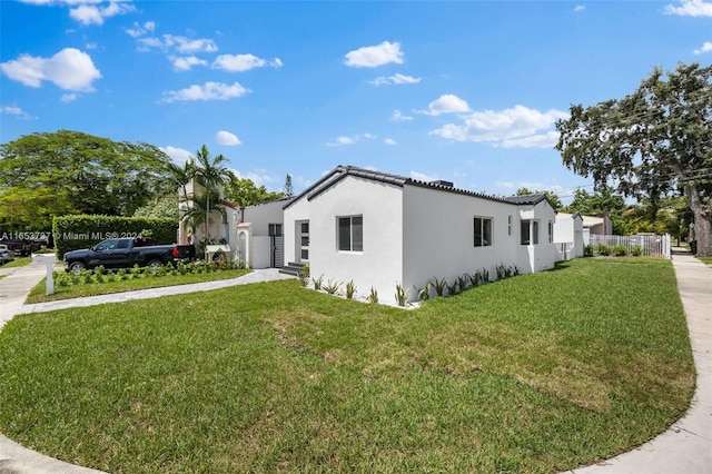 view of side of property with a yard