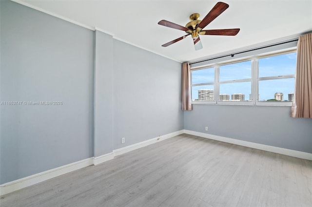 spare room with ornamental molding, ceiling fan, and light hardwood / wood-style floors