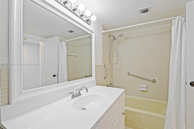 bathroom featuring shower / bath combo with shower curtain and vanity