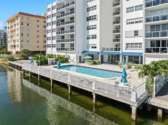 view of pool with a water view and a patio area