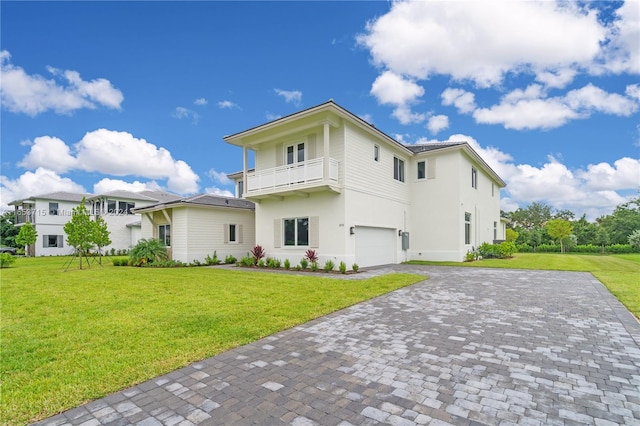 exterior space featuring a balcony, a garage, and a yard