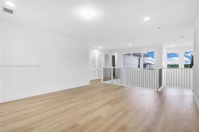 spare room featuring light hardwood / wood-style floors