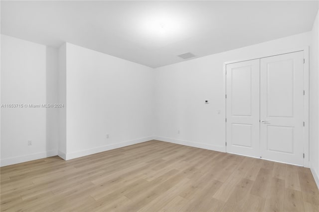 unfurnished bedroom featuring a closet and light hardwood / wood-style floors