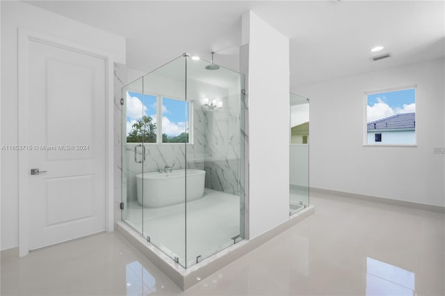 bathroom with plus walk in shower and tile patterned flooring