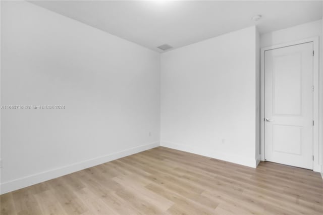 spare room with light hardwood / wood-style flooring