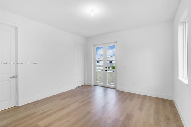 unfurnished room with light hardwood / wood-style flooring and french doors