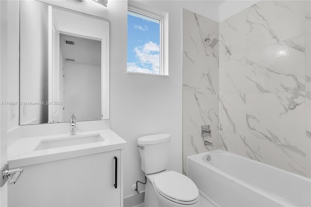 full bathroom with vanity, toilet, and tiled shower / bath combo