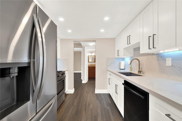 kitchen featuring white cabinetry, appliances with stainless steel finishes, dark hardwood / wood-style floors, and sink