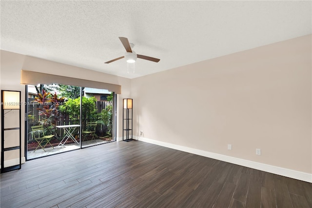 spare room with a textured ceiling, ceiling fan, and dark hardwood / wood-style flooring