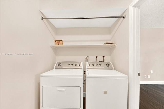 washroom featuring washer and dryer and dark hardwood / wood-style flooring