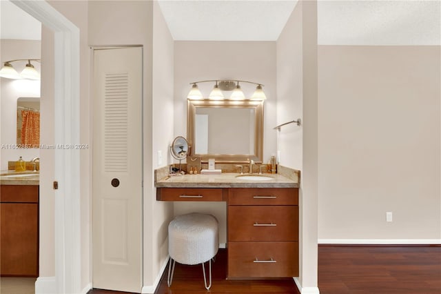 bathroom featuring a textured ceiling, wood-type flooring, and vanity