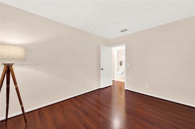 unfurnished room featuring dark hardwood / wood-style floors