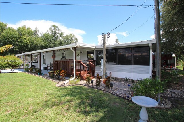 1113 Lissie Ln, Bulkhead Ridge, FL 34974 - view of front of property featuring a sunroom and a front lawn