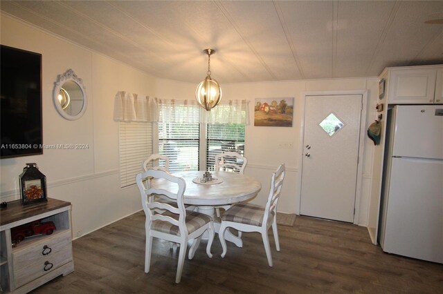 1113 Lissie Ln, Bulkhead Ridge, FL 34974 - dining room featuring an inviting chandelier and dark wood finished floors