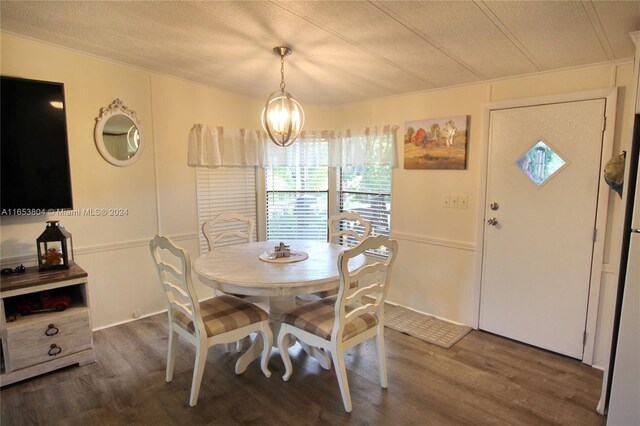 1113 Lissie Ln, Bulkhead Ridge, FL 34974 - dining area featuring a textured ceiling, a decorative wall, a chandelier, and dark wood finished floors