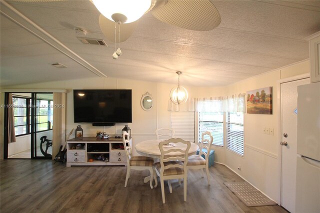 1113 Lissie Ln, Bulkhead Ridge, FL 34974 - dining room with vaulted ceiling, visible vents, wood finished floors, and a textured ceiling