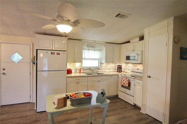 1113 Lissie Ln, Bulkhead Ridge, FL 34974 - kitchen featuring dark wood-style flooring, visible vents, white appliances, white cabinetry, and a sink