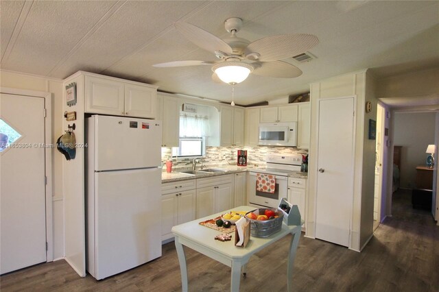 1113 Lissie Ln, Bulkhead Ridge, FL 34974 - kitchen with white cabinets, visible vents, white appliances, a sink, and dark wood-style floors