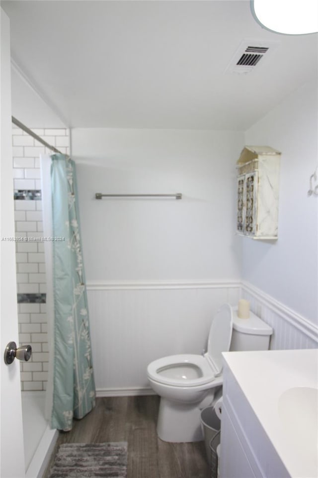 1113 Lissie Ln, Bulkhead Ridge, FL 34974 - bathroom with a wainscoted wall, toilet, a shower stall, wood finished floors, and visible vents