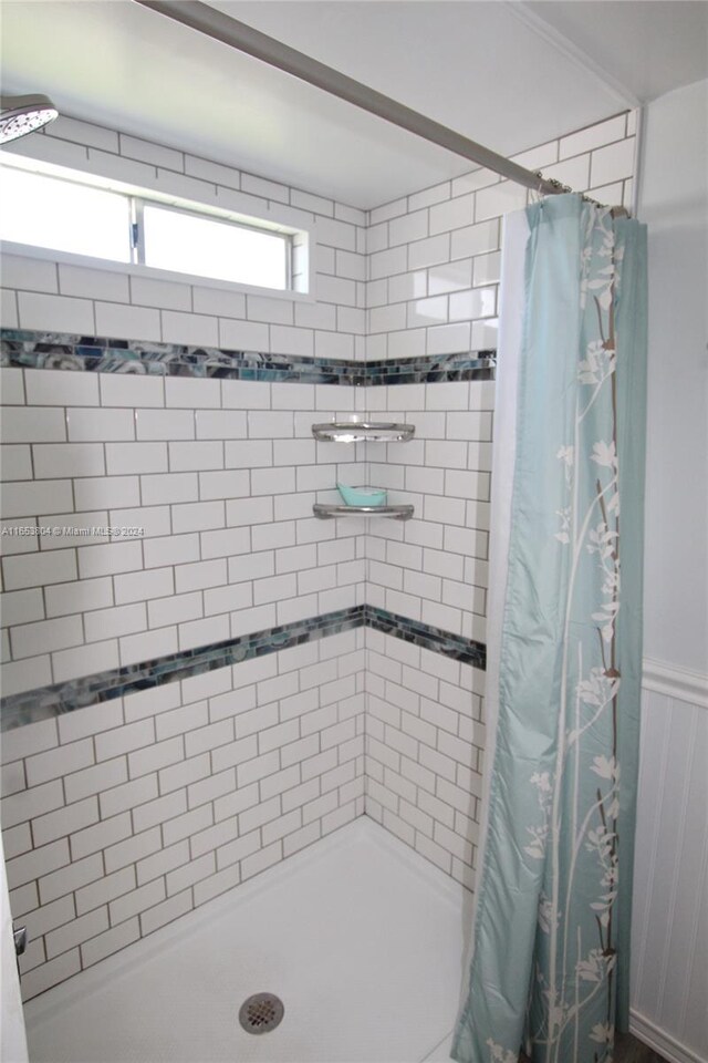 1113 Lissie Ln, Bulkhead Ridge, FL 34974 - bathroom featuring a shower stall and wainscoting