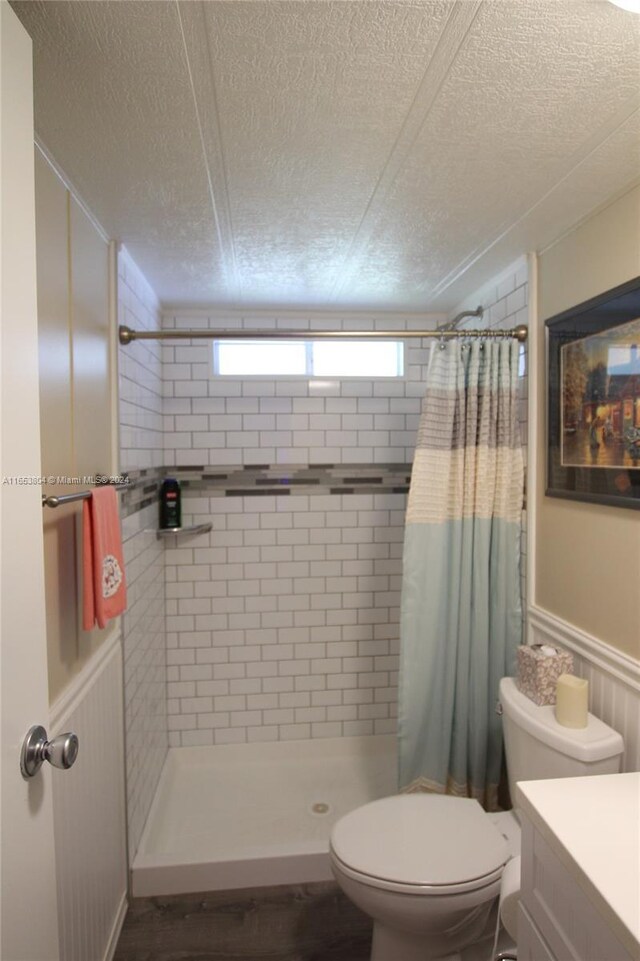 1113 Lissie Ln, Bulkhead Ridge, FL 34974 - bathroom featuring toilet, vanity, a stall shower, and wainscoting