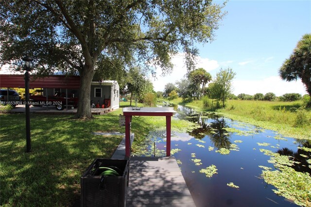 1113 Lissie Ln, Bulkhead Ridge, FL 34974 - view of dock featuring a water view and a yard