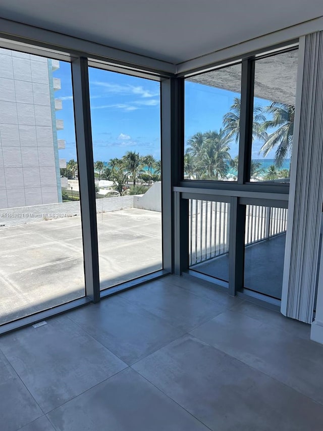 entryway with concrete floors and a wall of windows