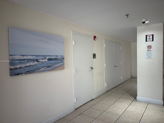 corridor with light tile patterned flooring