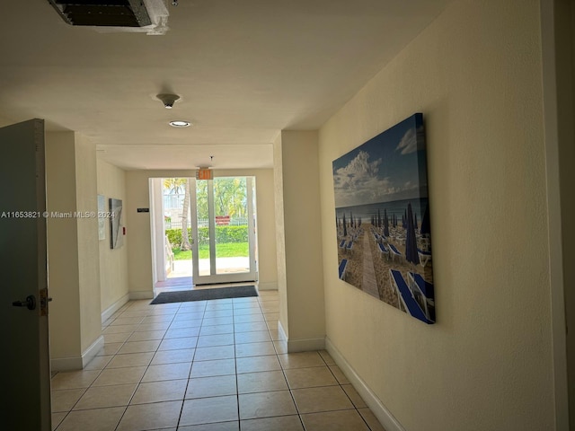 hall featuring light tile patterned floors