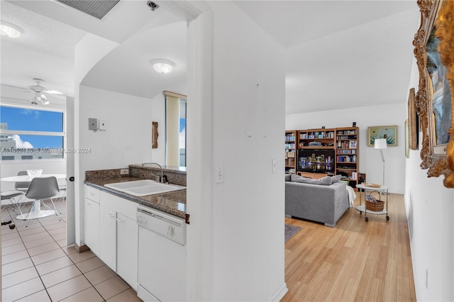 kitchen with white dishwasher, white cabinets, sink, light hardwood / wood-style flooring, and ceiling fan